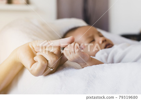 Close up of hands baby newborn holding mom finger,Family love concept Close up of hands baby newborn holding mom finger,Family love concept 79319680
