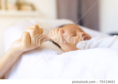 Close up of hand baby newborn holding mom fingers,Family love concept Close up of hand baby newborn holding mom fingers,Family love concept 79319681