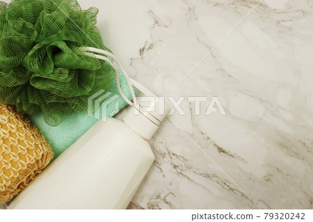 Shower accessories bath items shower bottle, sponge and fibre scrub on marble background 79320242