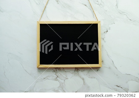 Empty black board on marble wall texture background 79320362