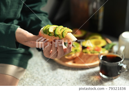Woman having breakfast in the kitchen. Woman having breakfast in the kitchen. 79321836