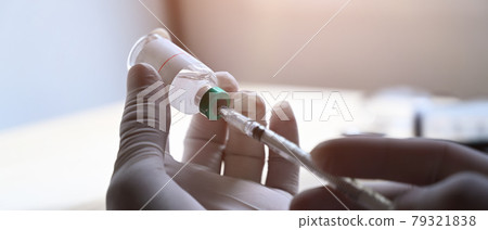 Doctor holding syringe with vaccine in hands. Doctor holding syringe with vaccine in hands. 79321838
