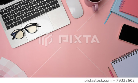Graphic designer workspace with laptop, smart phone, glasses and notebook on pink background. Graphic designer workspace with laptop, smart phone, glasses and notebook on pink background. 79322602