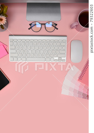 Designer workspace with computer, color swatch and glasses on pink background. Designer workspace with computer, color swatch and glasses on pink background. 79322603