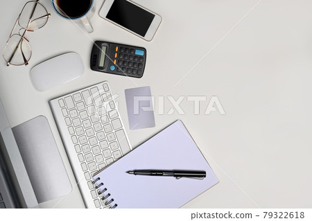 Top view white office desk with notebook, calculator, mobile phone and glasses. Top view white office desk with notebook, calculator, mobile phone and glasses. 79322618