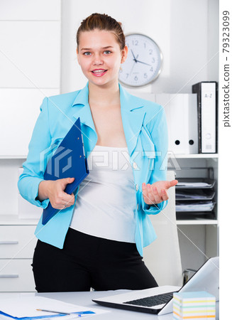 Female office worker is talking with partner before signing documents Female office worker is talking with partner before signing documents 79323099
