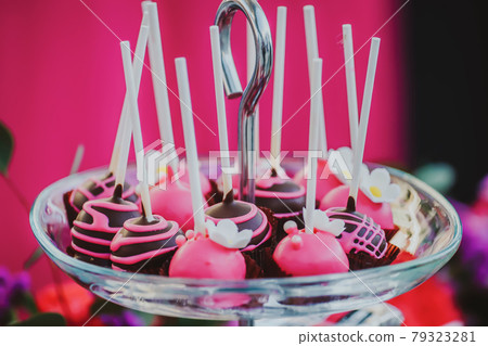 Chocolate cake pops on pink background party 79323281