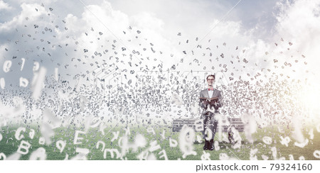 Young businessman or student studying the science and symbols fly around Young businessman or student studying the science and symbols fly around 79324160