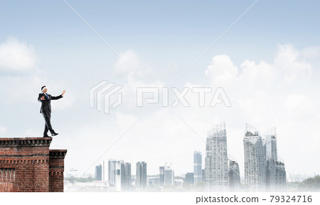 Danger and risk concept with businessman making step from edge 79324716