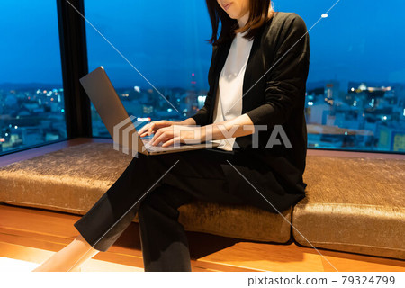A woman working remotely at a business hotel A woman working remotely at a business hotel 79324799