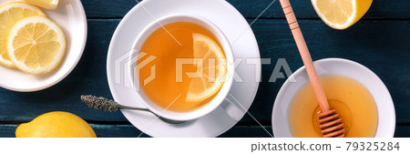 Lemon tea with honey panorama. The natural remedy of sweet raw honey 79325284