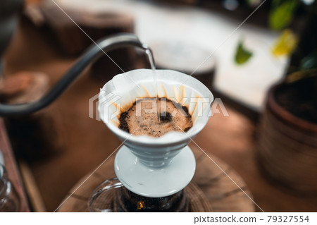 Pouring a hot water over a drip coffee 79327554