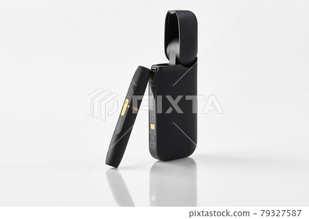New generation black electronic cigarette and open battery isolated on white. Hi-tech heating tobacco system. Advertising, close up New generation black electronic cigarette and open battery isolated on white. Hi-tech heating tobacco system. Advertising, close up 79327587