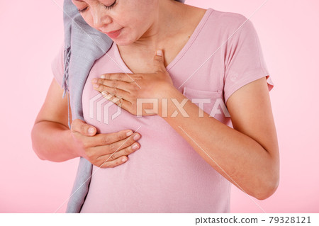 a asian women wearing headscarf disease with hand checking lumps on her breast for signs of breast mammary cancer isolated on white blank copy space studio background,medicine concept 79328121