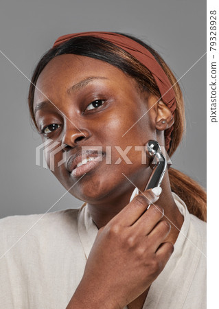 Beautiful African American Woman Enjoying Face Massage 79328928