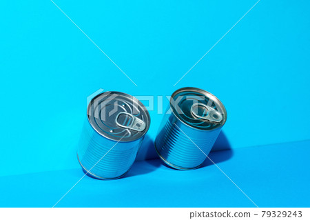 Tin can with food on blue background Tin can with food on blue background 79329243