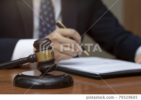 hand of legal profession on papers, gavel 79329685