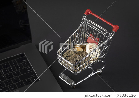 shopping cart miniature with bitcoin on laptop, cryptocurrency concept 79330120