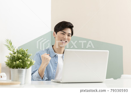 happy young Asian handsome man checking test, job result with laptop happy young Asian handsome man checking test, job result with laptop 79330593