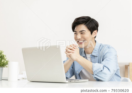 handsome young Asian job seeker checking result through laptop handsome young Asian job seeker checking result through laptop 79330620