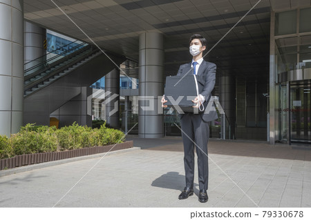 Asian man employee with mask leaving office with box due to lay off, covid 19 effects in business 79330678