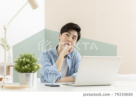 young Asian handsome man in deep thoughts, distressed, using laptop young Asian handsome man in deep thoughts, distressed, using laptop 79330680