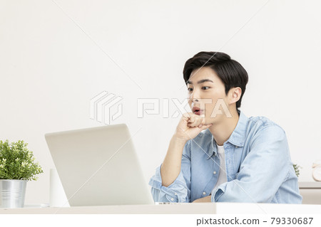young Asian handsome man surprised, using laptop young Asian handsome man surprised, using laptop 79330687