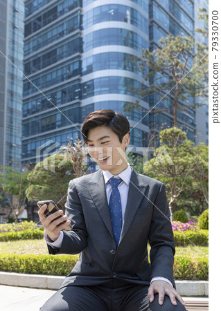 smiling young Asian handsome man, happy after passing job test smiling young Asian handsome man, happy after passing job test 79330700