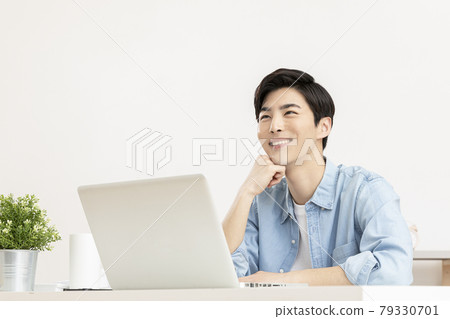 young Asian handsome man in deep thoughts, distressed, using laptop young Asian handsome man in deep thoughts, distressed, using laptop 79330701