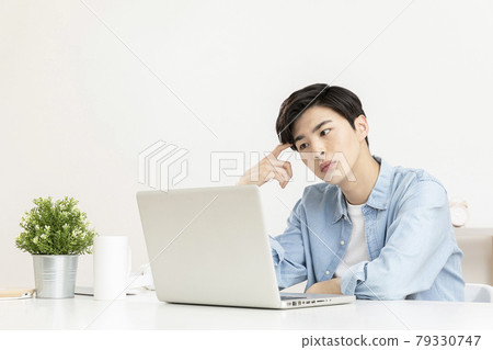 young Asian handsome man distressed, in worry, using laptop young Asian handsome man distressed, in worry, using laptop 79330747