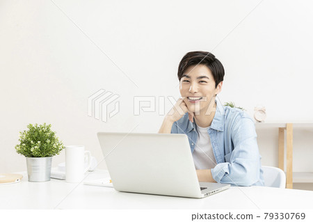 Asian handsome young man using laptop, remote work concept Asian handsome young man using laptop, remote work concept 79330769