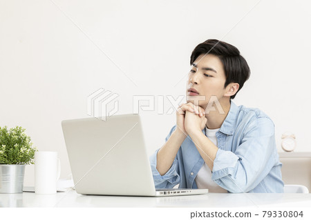 young Asian handsome man distressed, in worry, using laptop young Asian handsome man distressed, in worry, using laptop 79330804