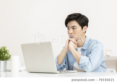 young Asian handsome man distressed, in worry, using laptop young Asian handsome man distressed, in worry, using laptop 79330815