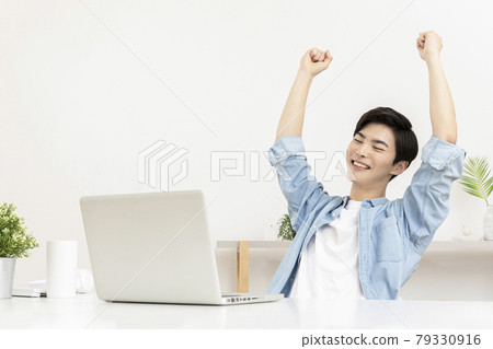 happy young Asian handsome man checking test, job result with laptop happy young Asian handsome man checking test, job result with laptop 79330916