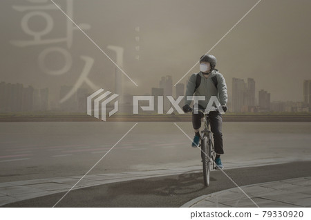 Asian delivery man riding bicycle in yellow dust Asian delivery man riding bicycle in yellow dust 79330920