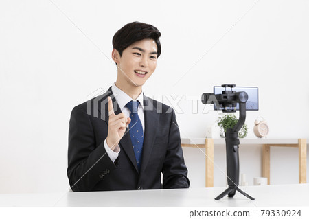 Asian young man in suit preparing untact online interview using smartphone Asian young man in suit preparing untact online interview using smartphone 79330924