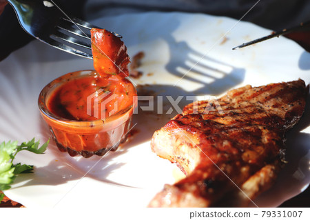 Pork steak on the bone with sauce Pork steak on the bone with sauce 79331007
