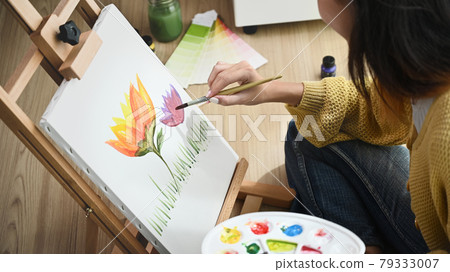 Closeup of painting process in art workshop creative positive woman painter paints at her studio. Closeup of painting process in art workshop creative positive woman painter paints at her studio. 79333007