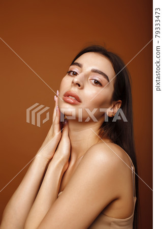 cute happy young indian woman posing cheerful on brown background in studio close up smiling, fashion beauty cute happy young indian woman posing cheerful on brown background in studio close up smiling, fashion beauty 79333473