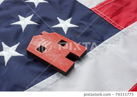 VA Streamline Refinance for home loan concept. A small house lies on the American flag. VA Streamline Refinance for home loan concept. A small house lies on the American flag. 79333775