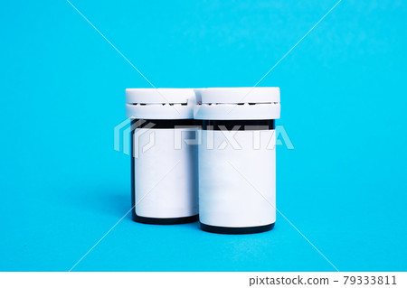 Two jars of medicines on a blue background Two jars of medicines on a blue background 79333811