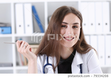 Beautiful smiling female doctor with silver pen Beautiful smiling female doctor with silver pen 79334208
