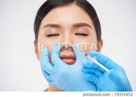 Woman Getting Nonsurgical Rhinoplasty 79334852