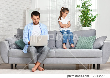offended little child daughter and father while he working 79335589