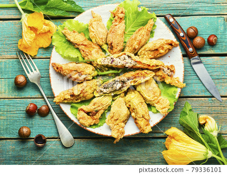 Stuffed zucchini or courgette flowers,flat lay Stuffed zucchini or courgette flowers,flat lay 79336101