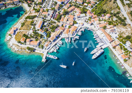 Beautiful Fiscardo village at Kefalonia or Cephalonia Island. Yachting bay and a ferry ship in the port 79336119