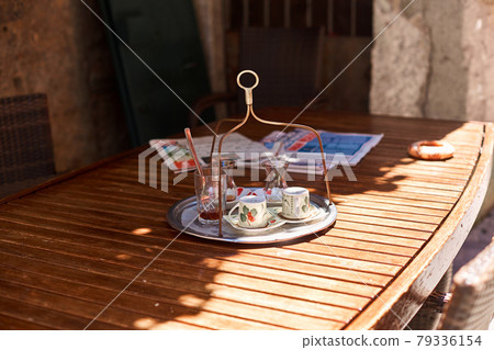 Traditional Turkish tea glasses. On the table of a street cafe, summer day 79336154