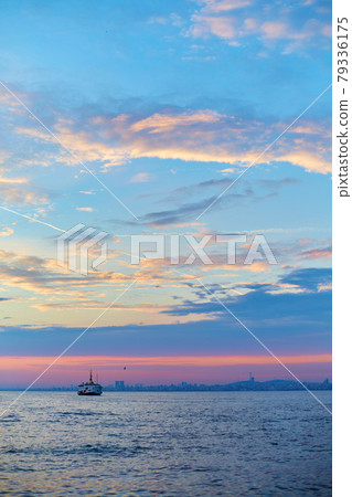 Sunset in the Bosphorus. A ship is sailing in the water 79336175