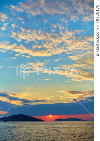 Sunset in the Bosphorus. A ship is sailing in the water 79336176