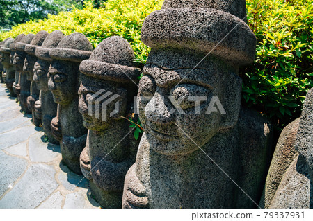 Dol hareubang stone grandpa sculpture at Cheonjiyeon Falls in Jeju Island, Korea Dol hareubang stone grandpa sculpture at Cheonjiyeon Falls in Jeju Island, Korea 79337931